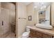 Modern bathroom featuring a tiled shower, vanity, and chandelier lighting fixture at 5079 Mountain Top Cir, Las Vegas, NV 89148