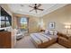 Comfortable bedroom featuring a ceiling fan, large window, and neutral color palette at 5079 Mountain Top Cir, Las Vegas, NV 89148