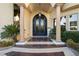 Elegant entryway featuring a stunning iron door, columns, and lush landscaping at 5079 Mountain Top Cir, Las Vegas, NV 89148