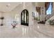 Grand foyer with a wrought-iron staircase, marble floors, and arched doorway at 5079 Mountain Top Cir, Las Vegas, NV 89148