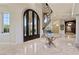 Impressive foyer with marble floors, a grand staircase, ornate iron doors, and elegant lighting at 5079 Mountain Top Cir, Las Vegas, NV 89148