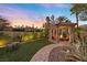 Charming gazebo in a beautifully landscaped backyard offers a cozy spot for outdoor dining and relaxation by the fireplace at 5079 Mountain Top Cir, Las Vegas, NV 89148