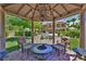Picturesque backyard gazebo with chandelier and seating area, surrounded by lush greenery at 5079 Mountain Top Cir, Las Vegas, NV 89148