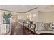 Hallway with hardwood flooring and decorative iron railings at 5079 Mountain Top Cir, Las Vegas, NV 89148