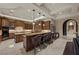 Kitchen featuring custom wood cabinetry, stone countertops, high-end appliances, and a breakfast bar at 5079 Mountain Top Cir, Las Vegas, NV 89148