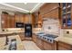 Gourmet kitchen with custom wood cabinetry, granite countertops, and stainless steel appliances at 5079 Mountain Top Cir, Las Vegas, NV 89148