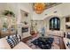 Elegant living room featuring fireplace, plush seating, and ornate chandelier at 5079 Mountain Top Cir, Las Vegas, NV 89148