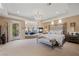 Spacious main bedroom suite with a fireplace, sitting area, and access to a private balcony at 5079 Mountain Top Cir, Las Vegas, NV 89148
