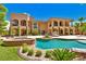 Backyard with a stunning pool, spa, covered patio, and lush landscaping perfect for outdoor living at 5079 Mountain Top Cir, Las Vegas, NV 89148