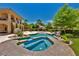 Inviting pool area featuring a spa, palm trees, and a lush, landscaped backyard at 5079 Mountain Top Cir, Las Vegas, NV 89148