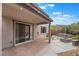 Covered backyard patio with brick trim and a gas fire pit at 5981 Smith Valley Rd, Las Vegas, NV 89148