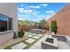Landscaped backyard featuring an in-ground hot tub, fire pit, and easy-care artificial turf at 5981 Smith Valley Rd, Las Vegas, NV 89148