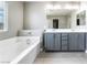 This bathroom features a double sink vanity and a soaking tub perfect for relaxation at 5981 Smith Valley Rd, Las Vegas, NV 89148