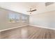 Bright and airy bedroom with wood-style laminate flooring and large windows, offering plenty of natural light at 5981 Smith Valley Rd, Las Vegas, NV 89148
