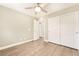 Bedroom with modern ceiling fan, wood-look floors, and closet with sliding doors at 5981 Smith Valley Rd, Las Vegas, NV 89148