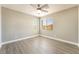Bedroom featuring wood-look flooring, neutral paint, ceiling fan, and two large windows at 5981 Smith Valley Rd, Las Vegas, NV 89148