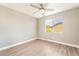 Bedroom featuring wood-look flooring, neutral paint, ceiling fan, and a large window at 5981 Smith Valley Rd, Las Vegas, NV 89148