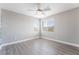 Inviting bedroom featuring light grey walls, light wood laminate flooring, and natural light at 5981 Smith Valley Rd, Las Vegas, NV 89148