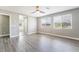 A view of a spacious room, with laminate floors and views of the outdoors at 5981 Smith Valley Rd, Las Vegas, NV 89148