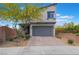 Inviting two-story home with a well-maintained lawn and a charming desert landscaped front yard at 5981 Smith Valley Rd, Las Vegas, NV 89148