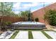 Backyard hot tub is set on a stone platform near modern pavers, and a lush garden, creating a peaceful oasis at 5981 Smith Valley Rd, Las Vegas, NV 89148