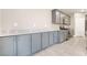 Modern kitchen showcasing sleek gray cabinets, quartz countertops, and stainless steel appliances at 5981 Smith Valley Rd, Las Vegas, NV 89148