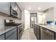 Modern kitchen features gray cabinets, stainless steel appliances, and granite countertops at 5981 Smith Valley Rd, Las Vegas, NV 89148