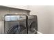 Modern laundry room featuring a front-loading washer and dryer set for convenient laundry care at 5981 Smith Valley Rd, Las Vegas, NV 89148
