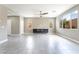 Bright living room with large windows, tile floors, and a modern ceiling fan at 5981 Smith Valley Rd, Las Vegas, NV 89148