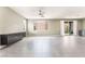 Spacious living room with large windows, tile flooring and dark built-in storage at 5981 Smith Valley Rd, Las Vegas, NV 89148