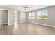 Spacious main bedroom featuring wood-look flooring, two windows, and neutral paint at 5981 Smith Valley Rd, Las Vegas, NV 89148