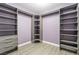 Spacious walk-in closet with ample shelving and modern grey wood-style laminate flooring at 5981 Smith Valley Rd, Las Vegas, NV 89148