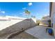Spacious backyard showcasing a concrete patio, desert landscaping, and tall block fencing, offering privacy at 6622 Black Oil Dr, Las Vegas, NV 89122