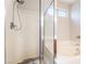 Bathroom featuring a shower with a rainfall showerhead and a soaking tub at 6622 Black Oil Dr, Las Vegas, NV 89122