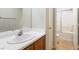 Bathroom featuring a wood vanity with a white sink, mirror, and shower at 6622 Black Oil Dr, Las Vegas, NV 89122