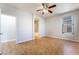 Empty room with tile floors, ceiling fan, and adjoining bathroom at 6622 Black Oil Dr, Las Vegas, NV 89122