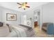 Staged bedroom with tile floors, ceiling fan, and adjoining bathroom at 6622 Black Oil Dr, Las Vegas, NV 89122