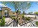 Community Entrance with lush landscaping and walking path. A picturesque welcome to the neighborhood at 6622 Black Oil Dr, Las Vegas, NV 89122