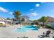 Community pool featuring palm trees, lounge chairs, and clear blue water for residents to enjoy at 6622 Black Oil Dr, Las Vegas, NV 89122