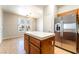 Bright kitchen and breakfast nook with a stainless steel refrigerator and chandelier at 6622 Black Oil Dr, Las Vegas, NV 89122