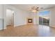 Open living room featuring fireplace, tile flooring, and sliding glass door at 6622 Black Oil Dr, Las Vegas, NV 89122