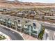 Aerial view of modern townhomes with solar panels nestled against a scenic mountain backdrop at 6821 Prairie Pearl St, Las Vegas, NV 89148