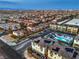 Extensive aerial view of a community with a pool, manicured landscaping, and views of the Las Vegas skyline at 6821 Prairie Pearl St, Las Vegas, NV 89148