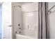 Bathroom featuring a shower-tub combo with white tiles and modern fixtures at 6821 Prairie Pearl St, Las Vegas, NV 89148