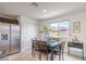 Cozy dining room with modern furnishings, and a scenic window view at 6821 Prairie Pearl St, Las Vegas, NV 89148
