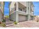 Well-maintained exterior featuring an attached two-car garage and an outdoor balcony at 6821 Prairie Pearl St, Las Vegas, NV 89148