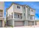 Townhome with a neutral color scheme, small balcony, and attached garage and desert landscaping at 6821 Prairie Pearl St, Las Vegas, NV 89148
