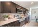 Modern kitchen with stainless steel appliances, sleek countertops, and dark wood cabinetry at 6821 Prairie Pearl St, Las Vegas, NV 89148