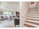 Open concept living room with stairs leading to the upper level, adjacent to kitchen area at 6821 Prairie Pearl St, Las Vegas, NV 89148