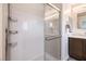 Shower with sliding glass doors, built-in shelving, and a modern design at 6821 Prairie Pearl St, Las Vegas, NV 89148